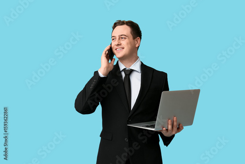 Happy young businessman wit...