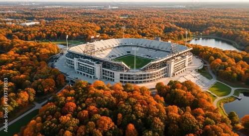 Autumn Aerial View of a Modern Sports Stadium Surrounded by Vibrant Fall Foliage and Serene Lakes