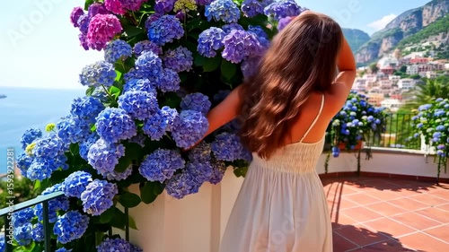 Woman Admiring Hydrangeas and Coastal Views in Positano, Italy