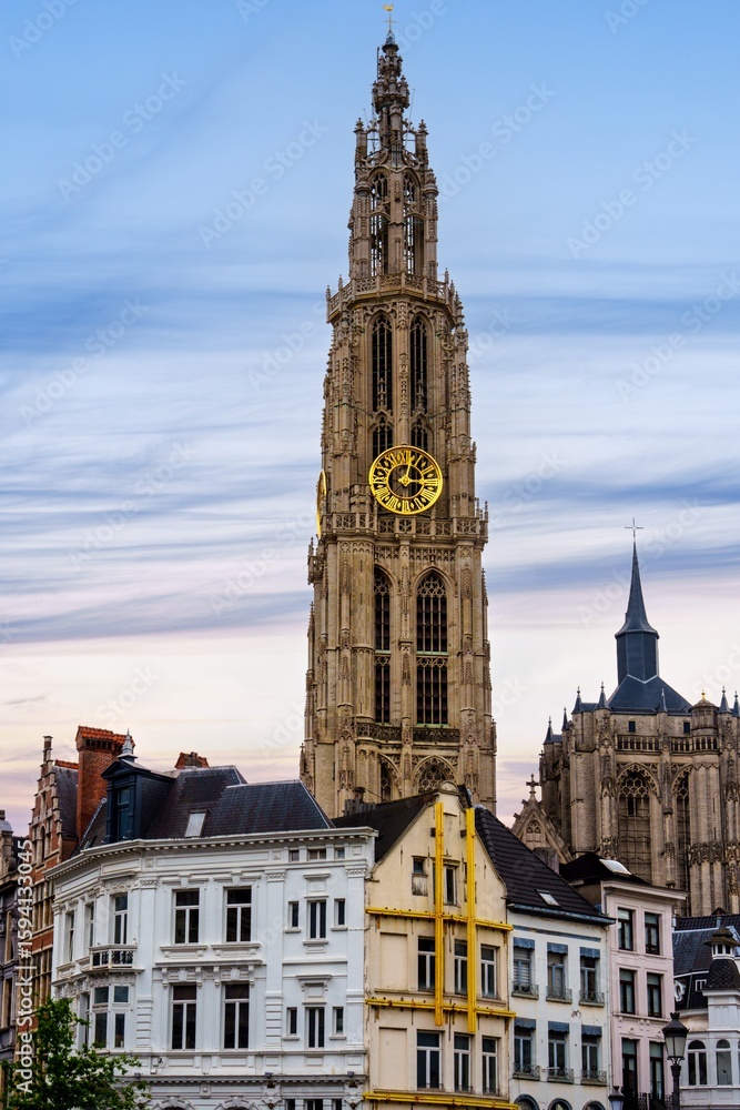 Fototapeta premium Explore the architectural beauty of Antwerp, Belgium. Admire the Gothic tower of the Cathedral of Our Lady, a symbol of the city s rich heritage and stunning architecture.