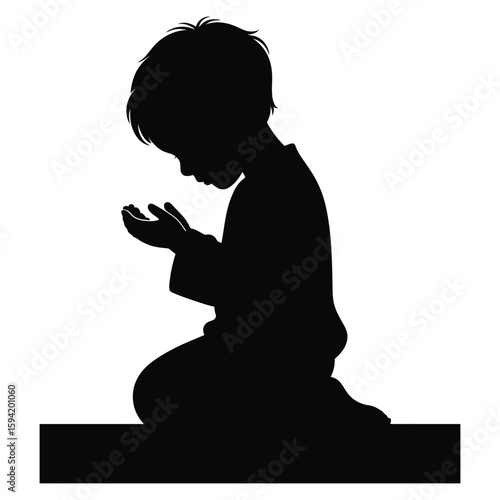 Black silhouette of a young boy kneeling with hands clasped in prayer child praying