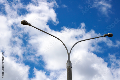Canvas Print A street light stands tall against a cloudy blue sky during evening