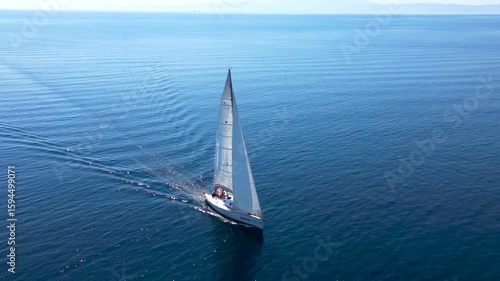 A sailboat sails the sea around the island of Thassos video footage taken by a drone