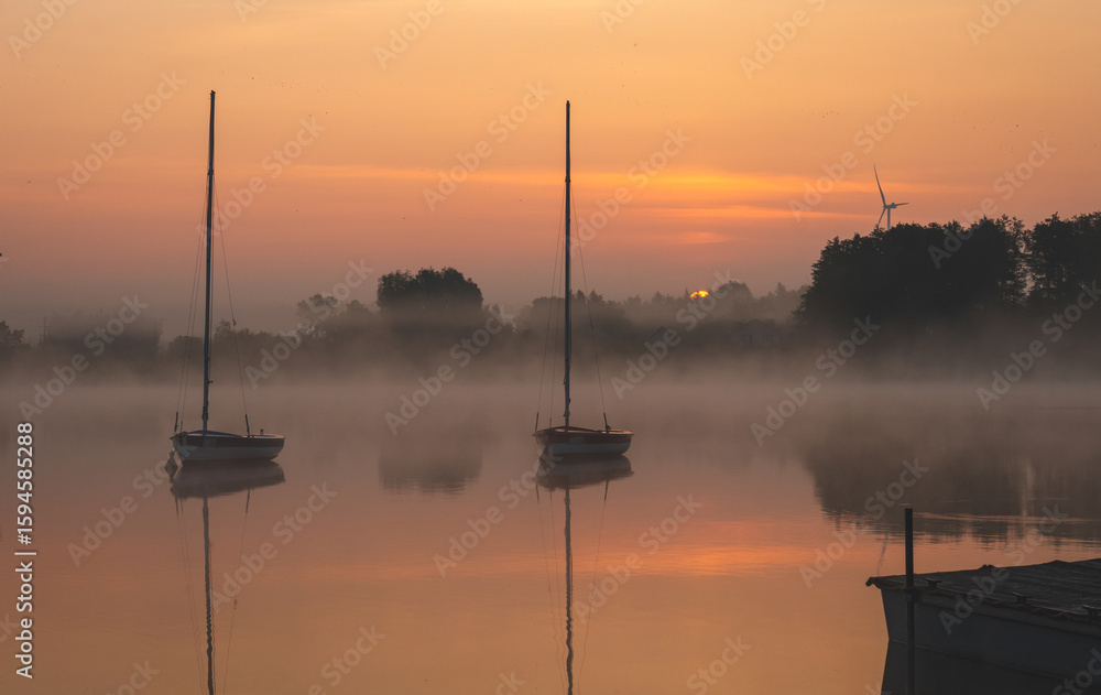 Naklejka premium Sunrise over the lake. Sunny June morning.