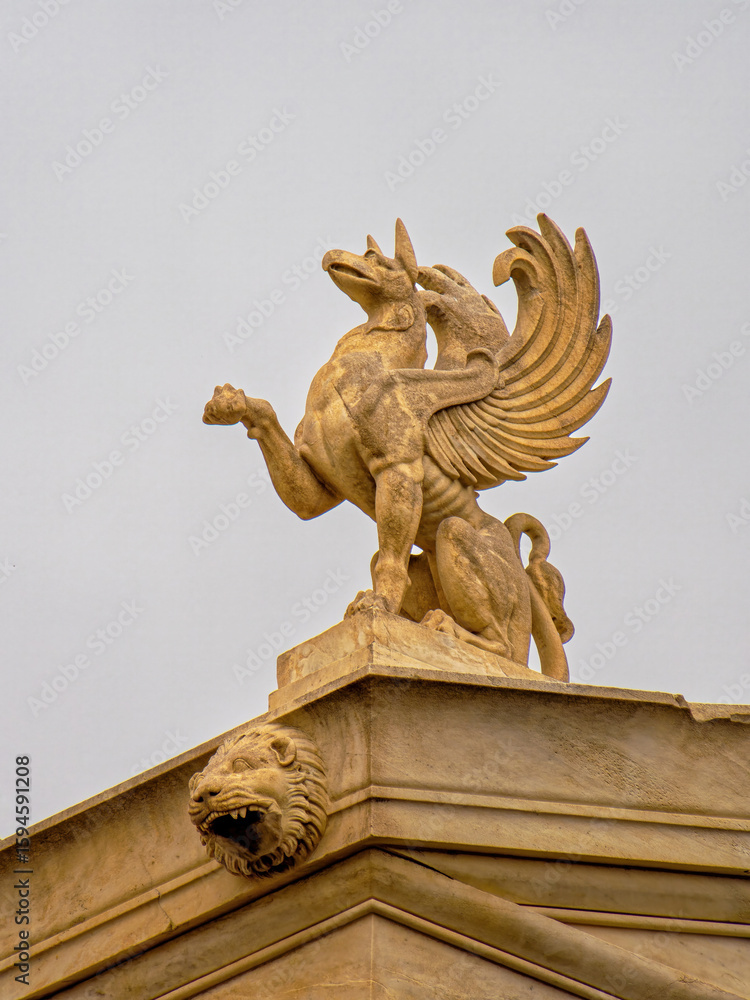 Obraz premium A griffin sculpture atop the National Academy of Greece in Athens, embodying mythological grandeur and classical artistry.