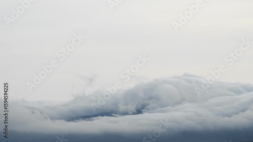 Wallpaper Mural Gloomy autumn landscape. Cloud tsunami. White dense clouds fly low over the mountain range, repeating its contours. Strong wind. Sunset. Autumn. Winter Torontodigital.ca