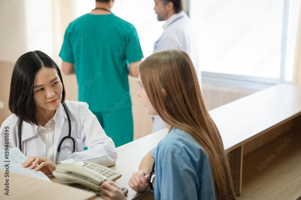 Obraz premium Asia doctor woman working and talking with Caucasian woman medical student at hospital 