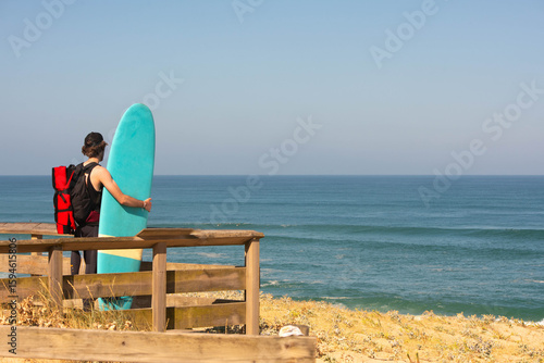 Surfer looking at the ocean before entering the water