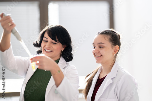 Wallpaper Mural Two scientists holding test tubes with yellow liquid Torontodigital.ca