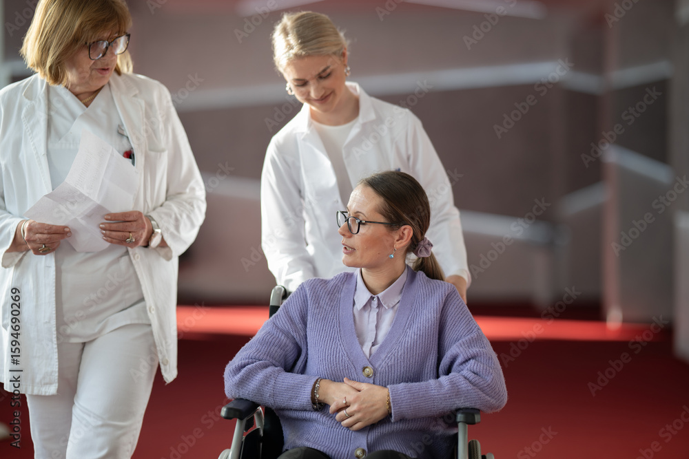 Fototapeta premium Doctor checking patients progress in wheelchair