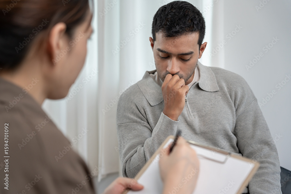 Fototapeta premium man with mental health problems is consulting. psychiatrist is recording the patient's condition for treatment. encouragement, love and family problem, bipolar , depression patient, protect suicide
