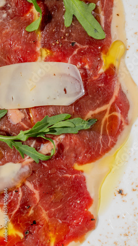 Valokuva Delicate carpaccio with emerald arugula, celebrating Italian Ferragosto and Nati