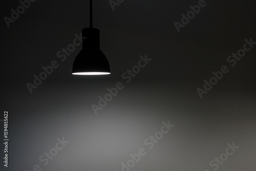 a shining hanged ceiling lamp without electric wire  with dark blue tone dirty concrete background wall