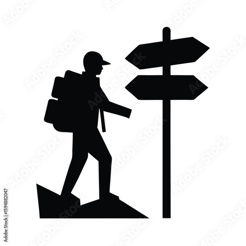Silhouette of a hiker at a trail signpost