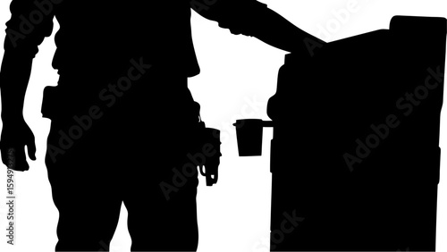 Silhouette of a person with tool belt interacting with a machine near a coffee cup in black and white