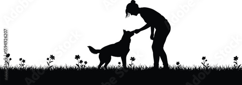 Silhouette of a woman bonding with her loyal dog in a vibrant flower field at sunset, symbolizing companionship and outdoor joy.
