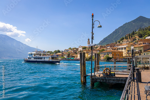 Wallpaper Mural Scenic waterfront of Limone sul Garda, with village buildings and mountains in the background. Torontodigital.ca