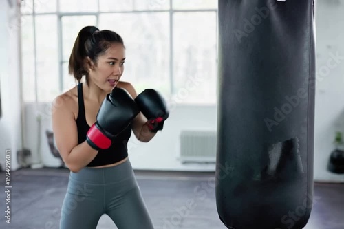 A determined athlete practices her boxing skills, her form a testament to discipline and dedication. the essence of strength, focus, and the journey of athletic achievement.