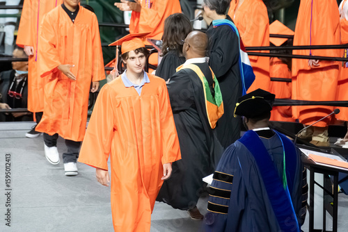 Student walking on stage during graduation ceremony