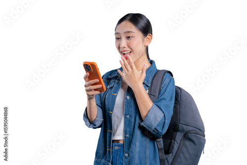 Photography An amazed young Asian student looking at her phone with a happy, surprised expression, reacting to exciting news