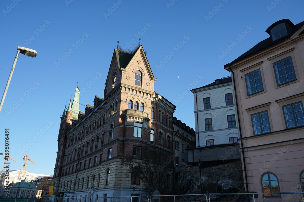 Fototapeta premium Low angle view of buildings against blue sky