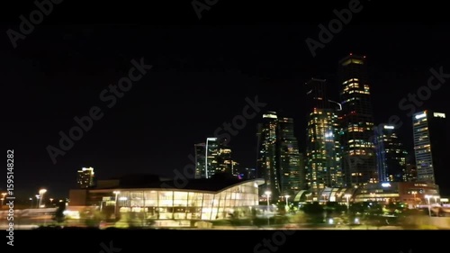 Wallpaper Mural Modern city skyline glowing at night with illuminated glass skyscrapers. Urban concept Torontodigital.ca