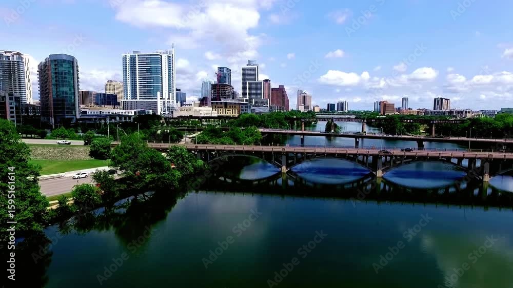 The austin texas skyline is reflected in the colorado river The austin texas skyline is reflected in the colorado river