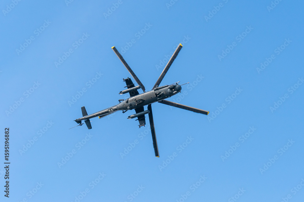 Fototapeta premium Soviet-made black old military helicopter flying in the sky in Budapest