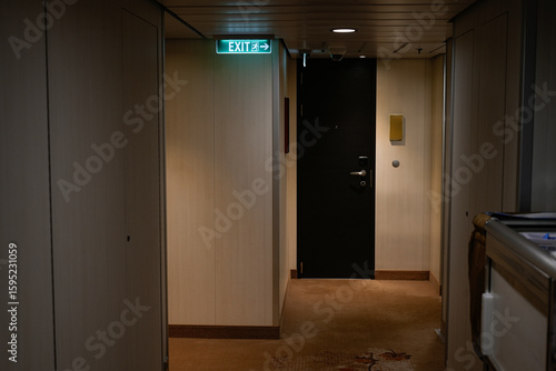 Konstfotografi modern hallway interior with room door and emergency exit indicator