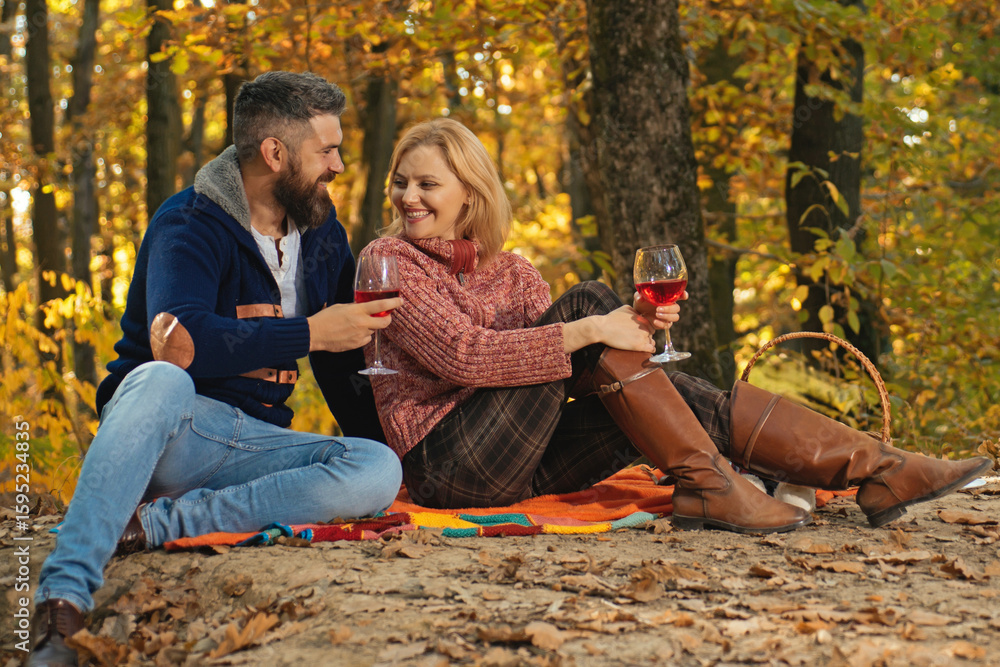 Fototapeta premium Couple on picnic. Couple in Autumn fall park. Man and woman near Autumn fall leaves.