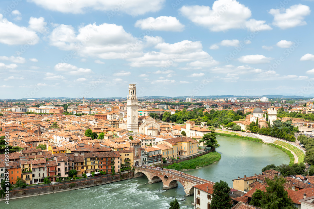 Fototapeta premium Ponte di Pietra over the Adige River and Lungargine dell'Adige in Verona. This ancient stone bridge offers scenic views and connects to the riverside promenade