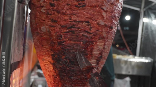 Mexican street food cutting up al pastor
