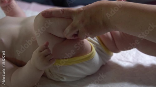 Wallpaper Mural Slow-motion video of bicycle leg massage for an infant under one year to improve hip and knee joint mobility. Pediatric physiotherapy technique Torontodigital.ca