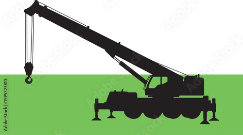 Black silhouette of a mobile crane on green ground