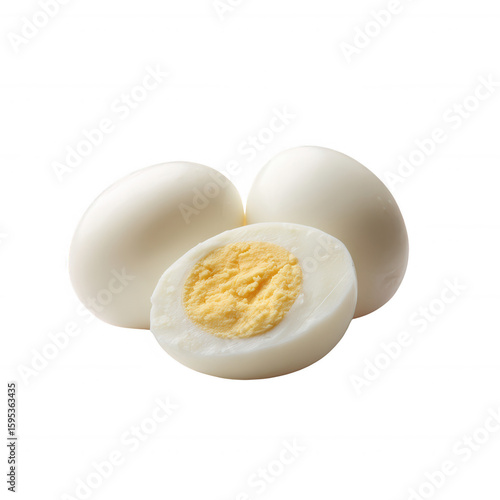 Three boiled eggs on a white background, showcasing one cut egg with a vibrant yellow yolk. Perfect for food-related themes and nutritional content.