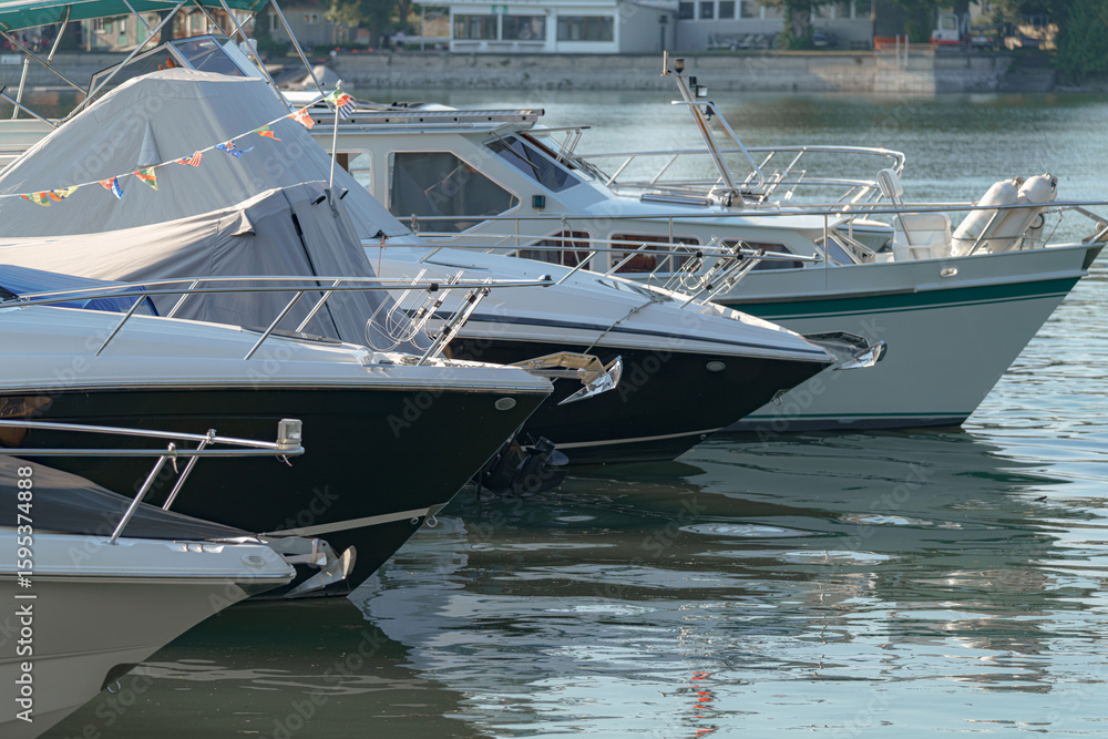 Fototapeta premium Boats docked at a tranquil marina during a sunny day