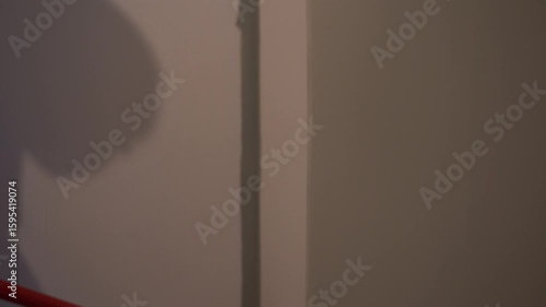 Painting the walls with a roller with pile. Close-up of movement along the wall. Apartment renovation. High quality 4k footage