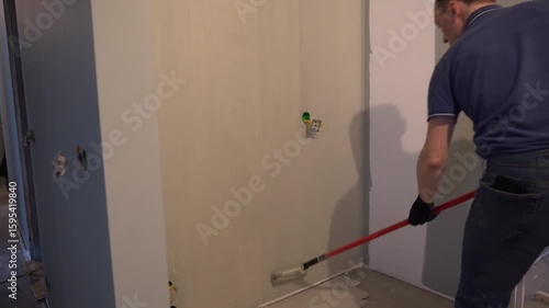 Painting walls with a paint roller for perfect wall painting. Roller movement from top to bottom. Grey paint on the surface. High quality 4k footage