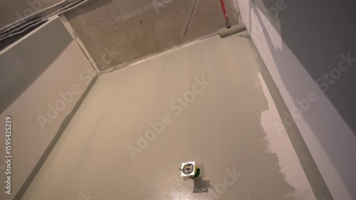 Bottom view of the wall, the repairman paints the walls with a pile roller for a perfect wall painting. Roller movement from top to bottom. High quality 4k footage