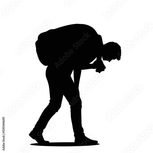 The silhouette of a man dragging his feet with a heavy burden, tired and unmotivated