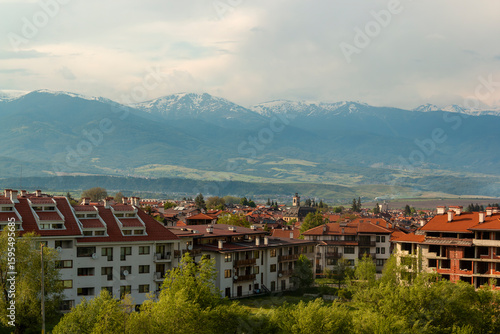 View of several guesthouses nestled in a valley below the Pirin Mountains in Bansko, southeastern Bulgaria