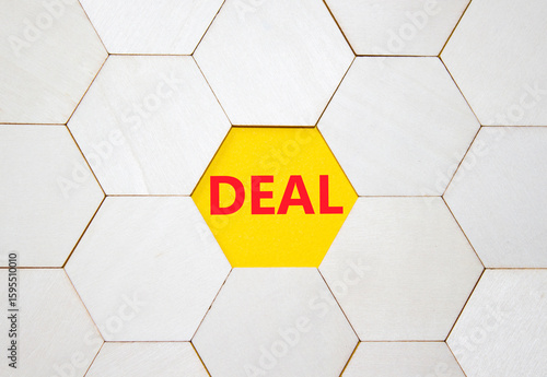 Deal symbol. Concept word Deal on wooden comb puzzle. Beautiful yellow background. Business and Deal concept. Copy space.