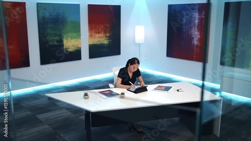Woman Working Alone in Artistic Modern Office Space