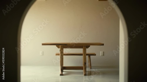 Wooden table and bench in a room with arches