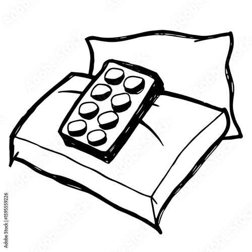 Pill pack resting on white bedsheet with pillow in background  