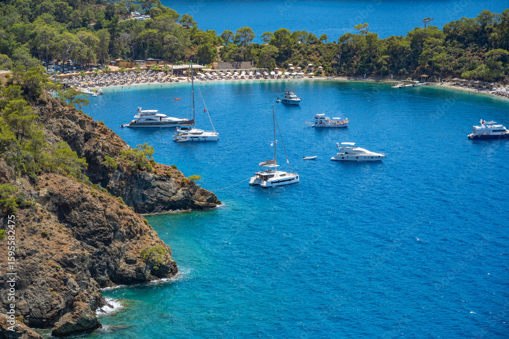 Obraz premium Boncuk Bay, Blue Lagoon and Oludeniz beach aerial panoramic view. Oludeniz is a beach resort in the Fethiye district of Mugla Province, Turkey.
