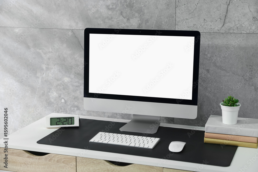 Fototapeta premium Stylish workplace with computer and black mousepad on white table indoors. Space for text