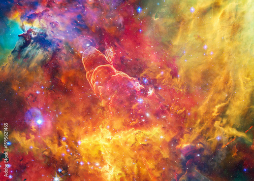 Fototapeta Naklejka Na Ścianę i Meble -  Multicolored structures of gas and dust swirl within a bright star-forming region of space, framed by glowing filaments and shadowed pockets. Elements of this illustration were furnished by NASA.
