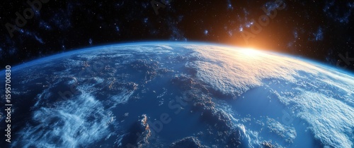 Fototapeta Naklejka Na Ścianę i Meble -  View of the Earth from space with sun rising over the horizon illuminating the atmosphere and clouds against a backdrop of stars