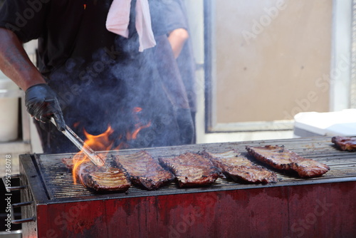 Lively summer scenes from a ribfest celebration featuring sizzling barbecue, smoked meats, and food vendor culture. A feast of flavor, fire, and community under warm seasonal skies in Columbus, Ohio.